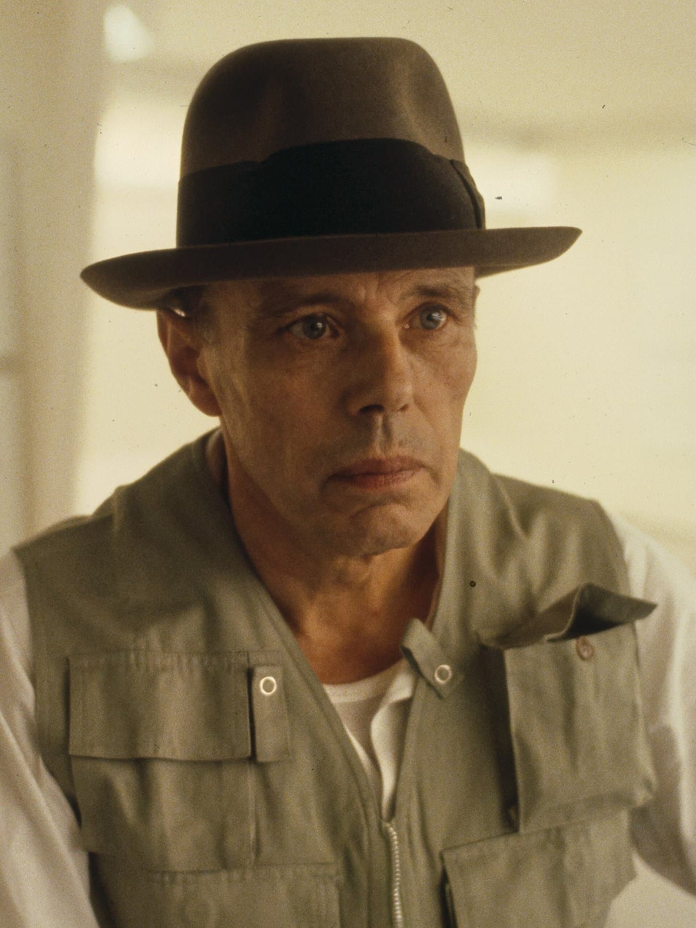 Joseph Beuys in his felt hat, looking past the camera.