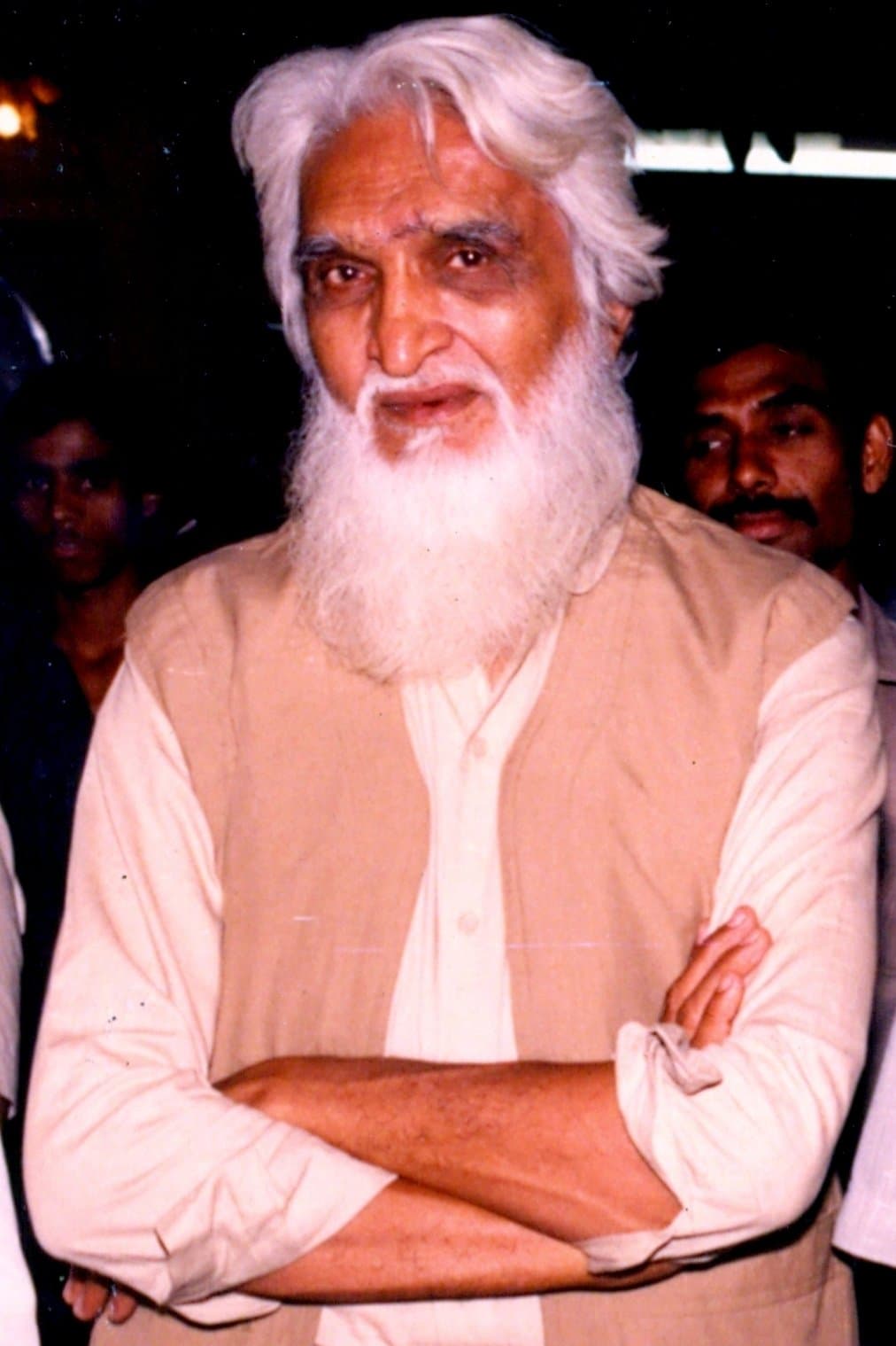 M. F. Husain with a long white beard, in a pale kurta.