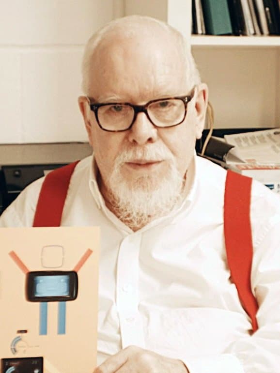 Sir Peter Blake, white-bearded, in black glasses and red braces.