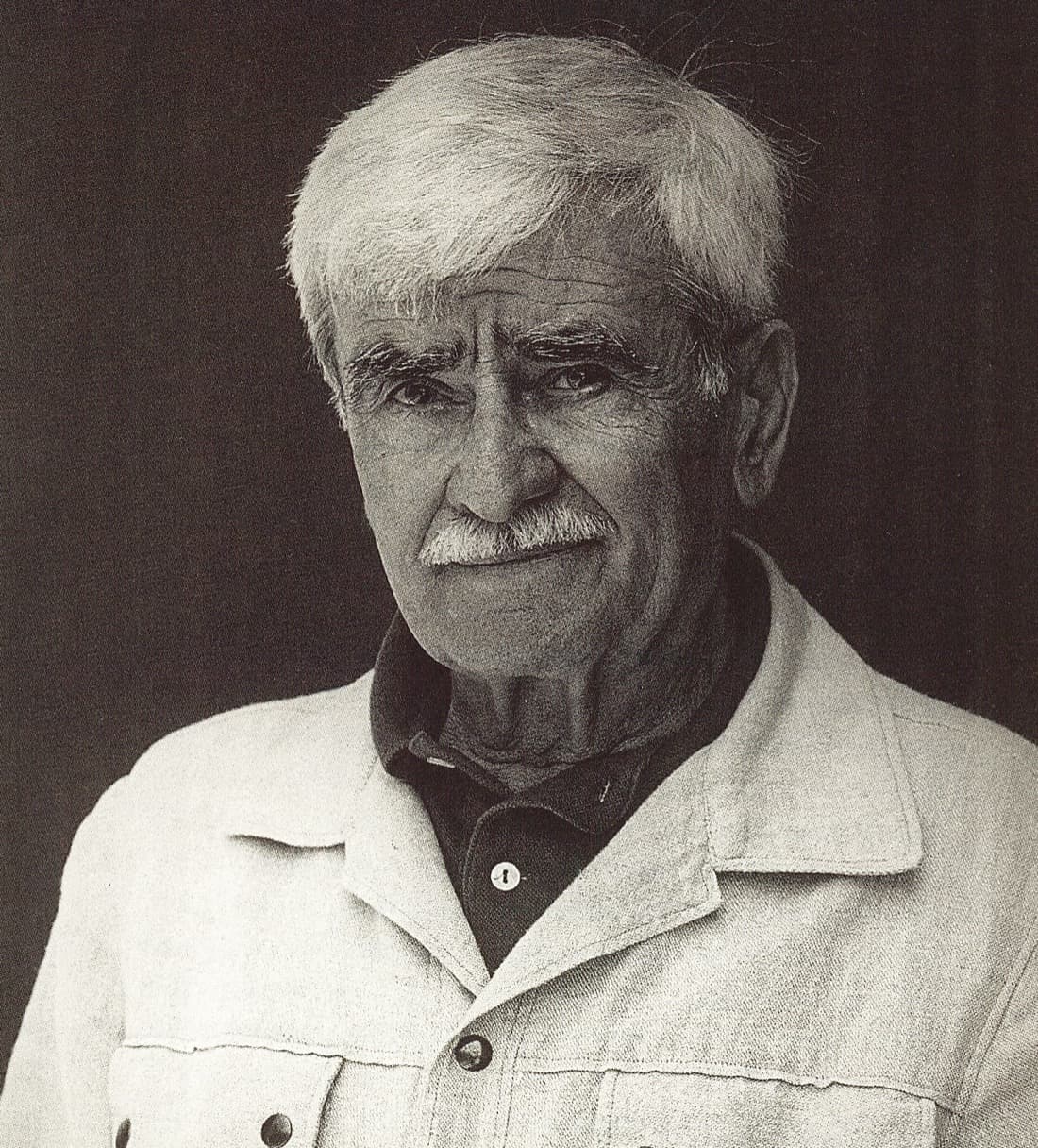 Alberto Burri in later life, with grey hair and a moustache, in black and white.