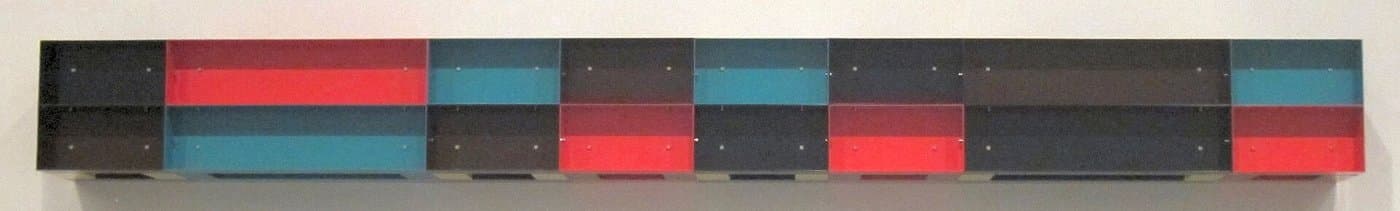 Detail of a Donald Judd wall work in painted aluminium, in blocks of red, blue and black.