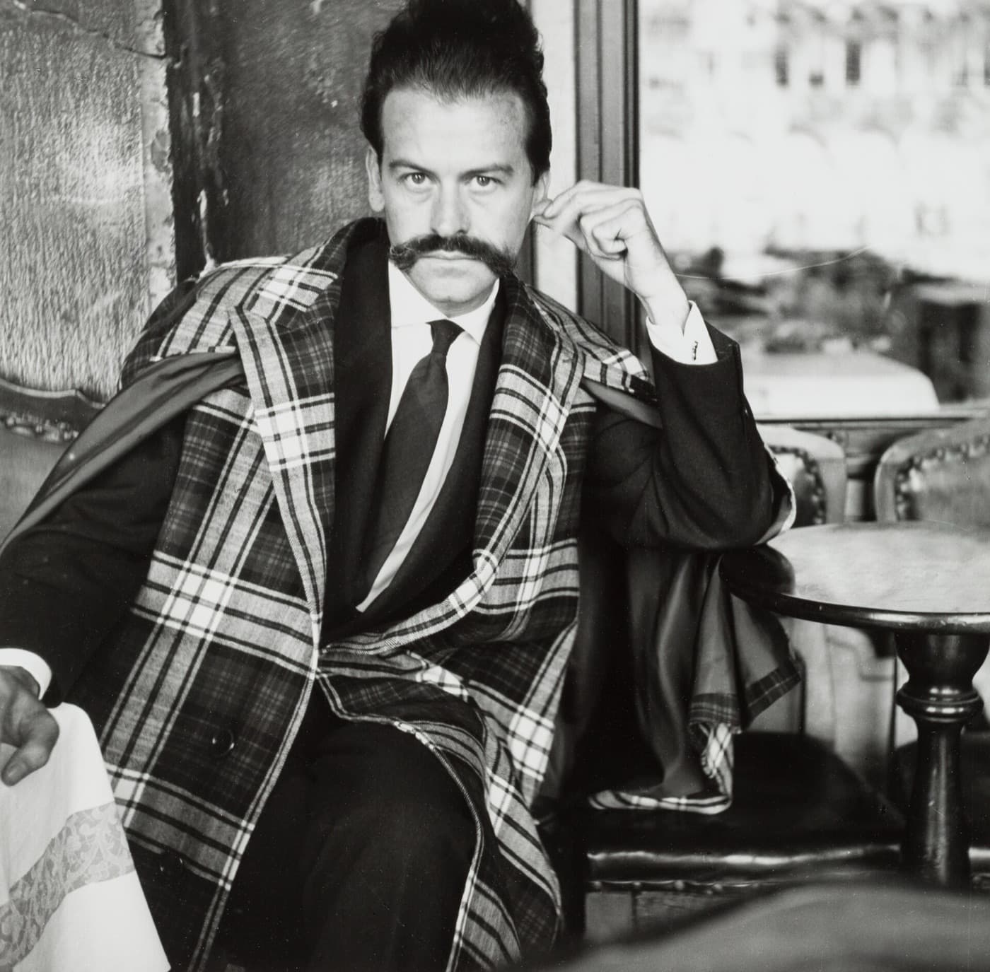 Georges Mathieu, with his waxed moustache, in a checked coat, in black and white.