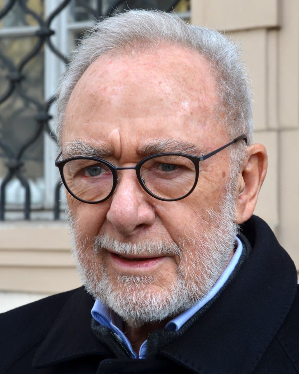 Gerhard Richter in dark round glasses, with a grey beard.