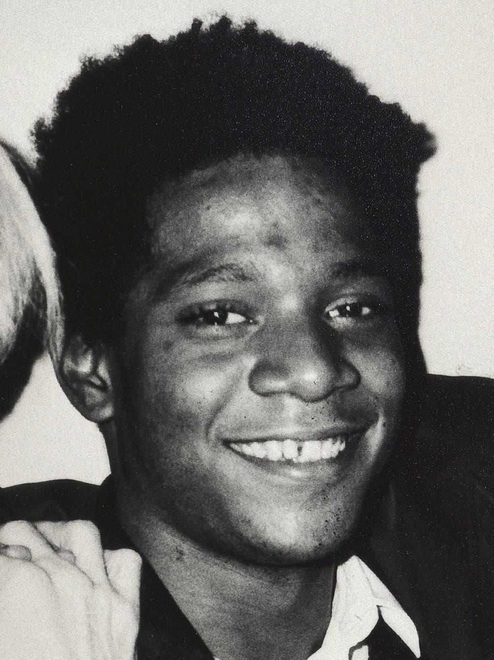 Jean-Michel Basquiat, close up, looking into the camera.