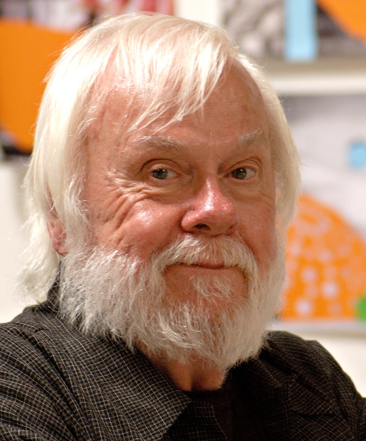 John Baldessari with white hair and a white beard, close up.