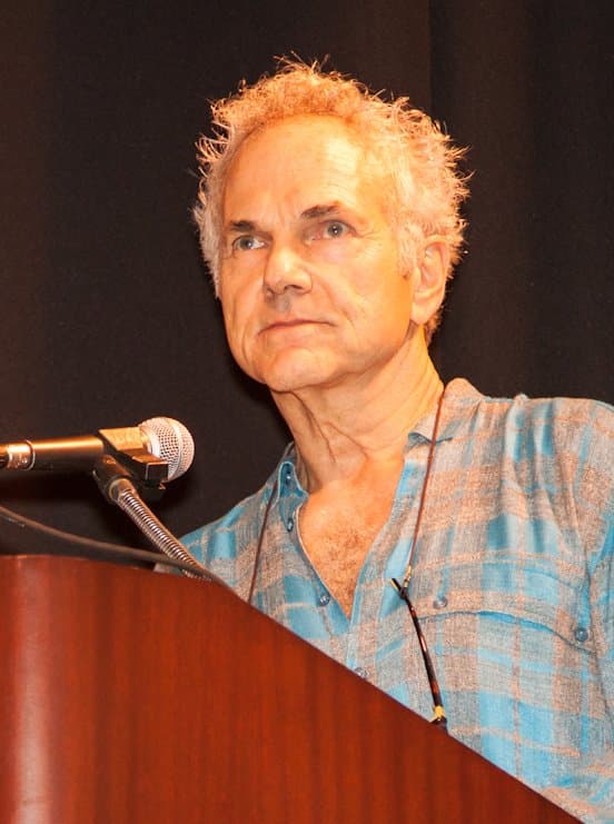 Richard Misrach at a microphone, lecturing.