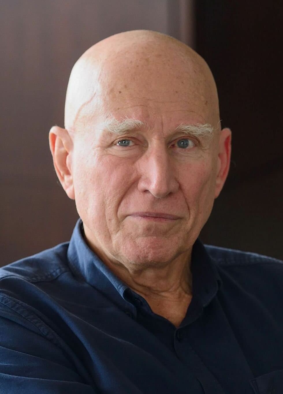 Sebastião Salgado, bald, with white eyebrows, in close-up.