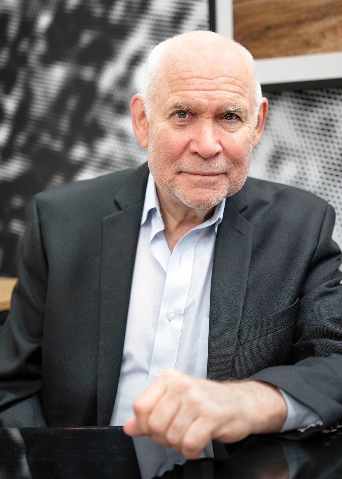 Steve McCurry in a dark jacket and open-necked shirt, seated and smiling slightly