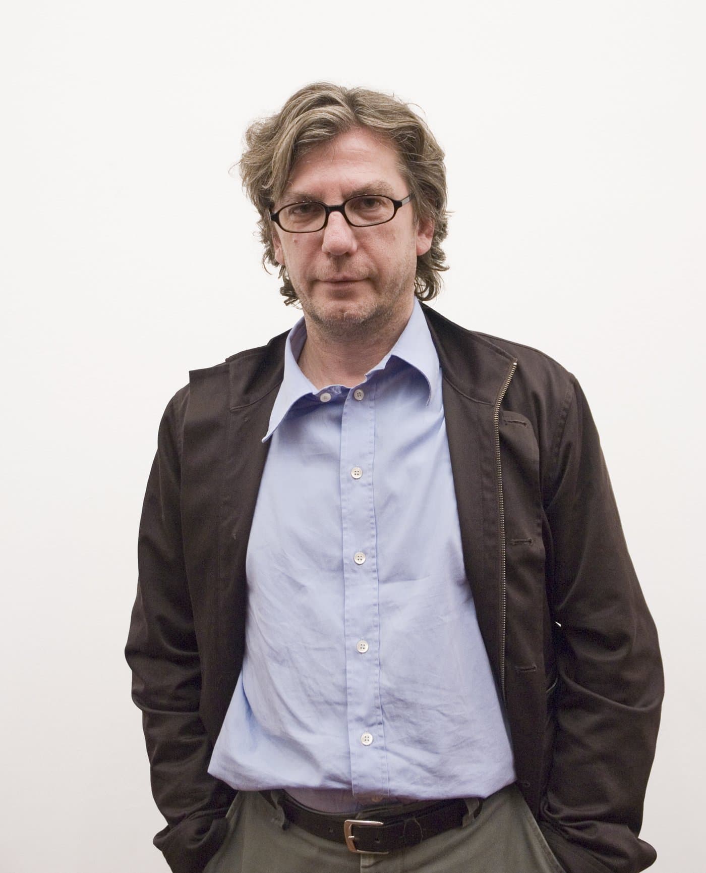 Thomas Ruff in glasses and a dark jacket over a blue shirt.