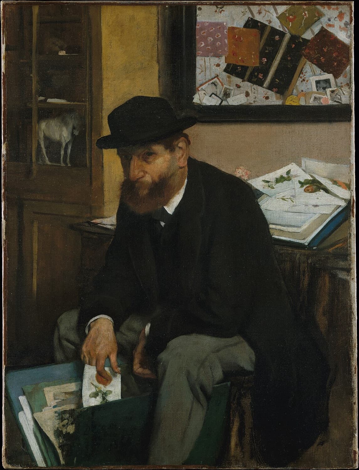 Degas's The Collector of Prints: a bearded man in a black bowler hat and coat sits beside a table piled with prints, drawing one from an open portfolio at his knee