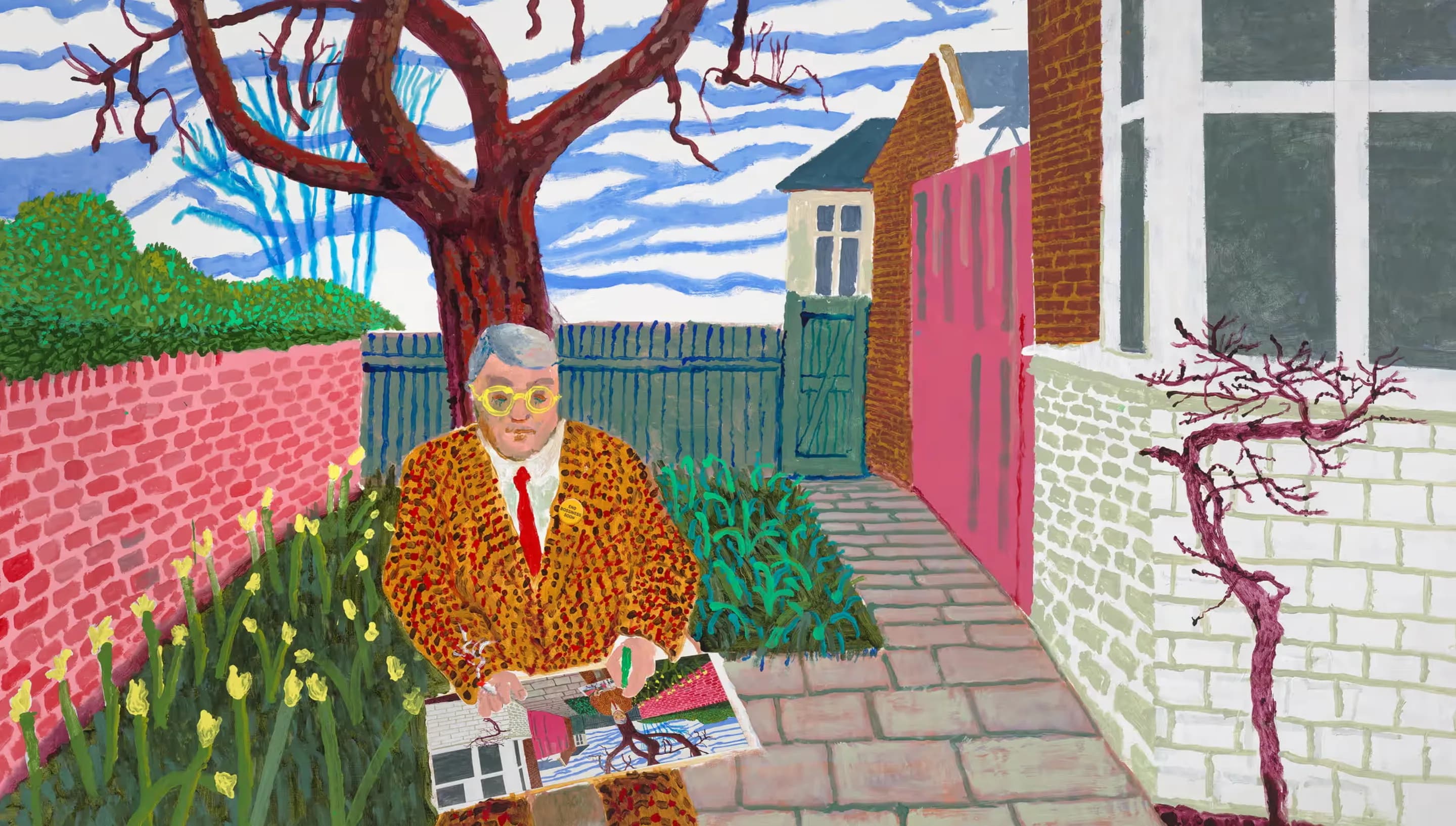 A David Hockney self-portrait in flat, bright colour: the artist in a leopard-print jacket and yellow round glasses, seated in a walled garden with a bare tree and daffodils, holding one of his own paintings
