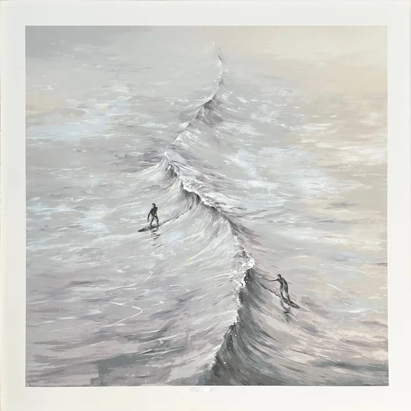 A Pejac print: two surfers on a long grey wave, worked in muted greys, pencil signed in the lower margin.