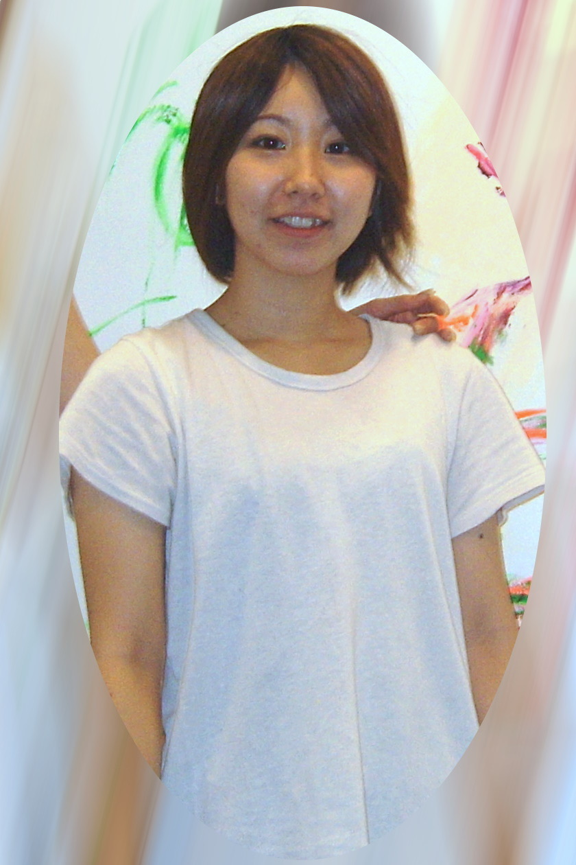 Ayako Rokkaku in a white T-shirt, standing in front of one of her paintings